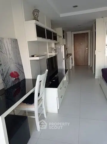 Modern apartment interior with sleek furniture and open layout, featuring a stylish kitchen and cozy living area.