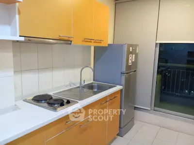 Modern kitchen with vibrant yellow cabinets and sleek stainless steel appliances