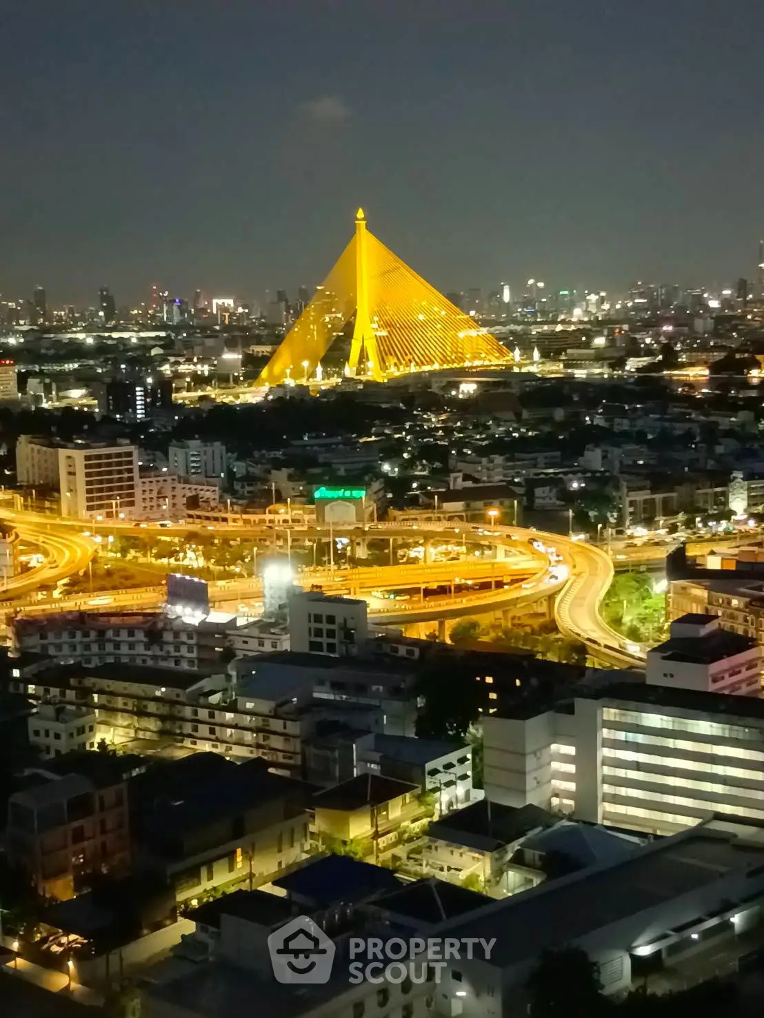 Stunning night view of cityscape with illuminated bridge and vibrant skyline.