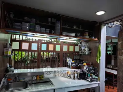 Charming kitchen with open layout and garden view, featuring modern appliances and ample storage space.