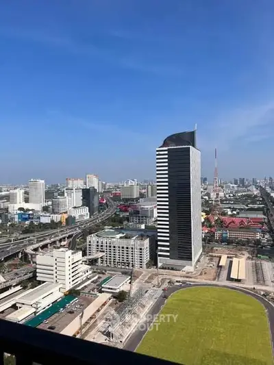 Stunning cityscape view from a high-rise balcony showcasing modern architecture and vibrant urban life.