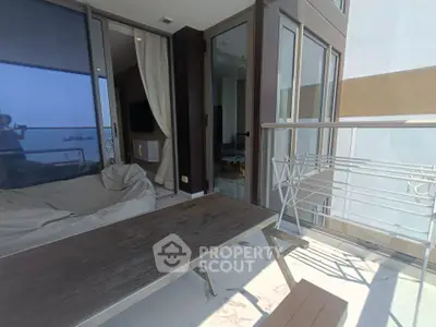 Spacious balcony with ocean view, perfect for relaxation and outdoor dining.
