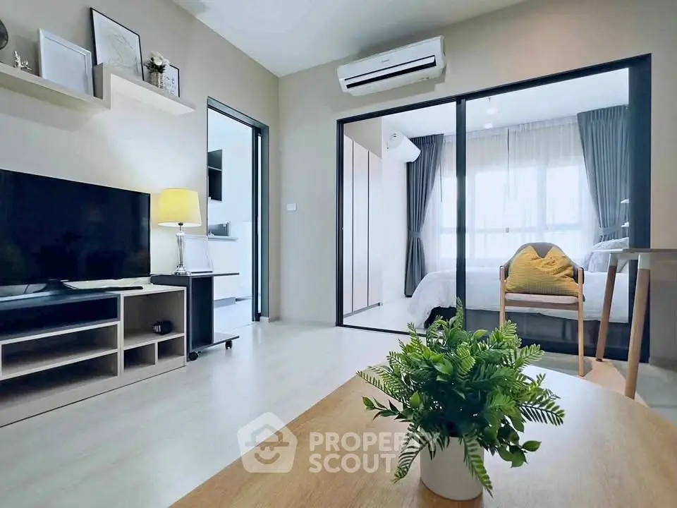 Modern living room with sleek design and cozy bedroom view