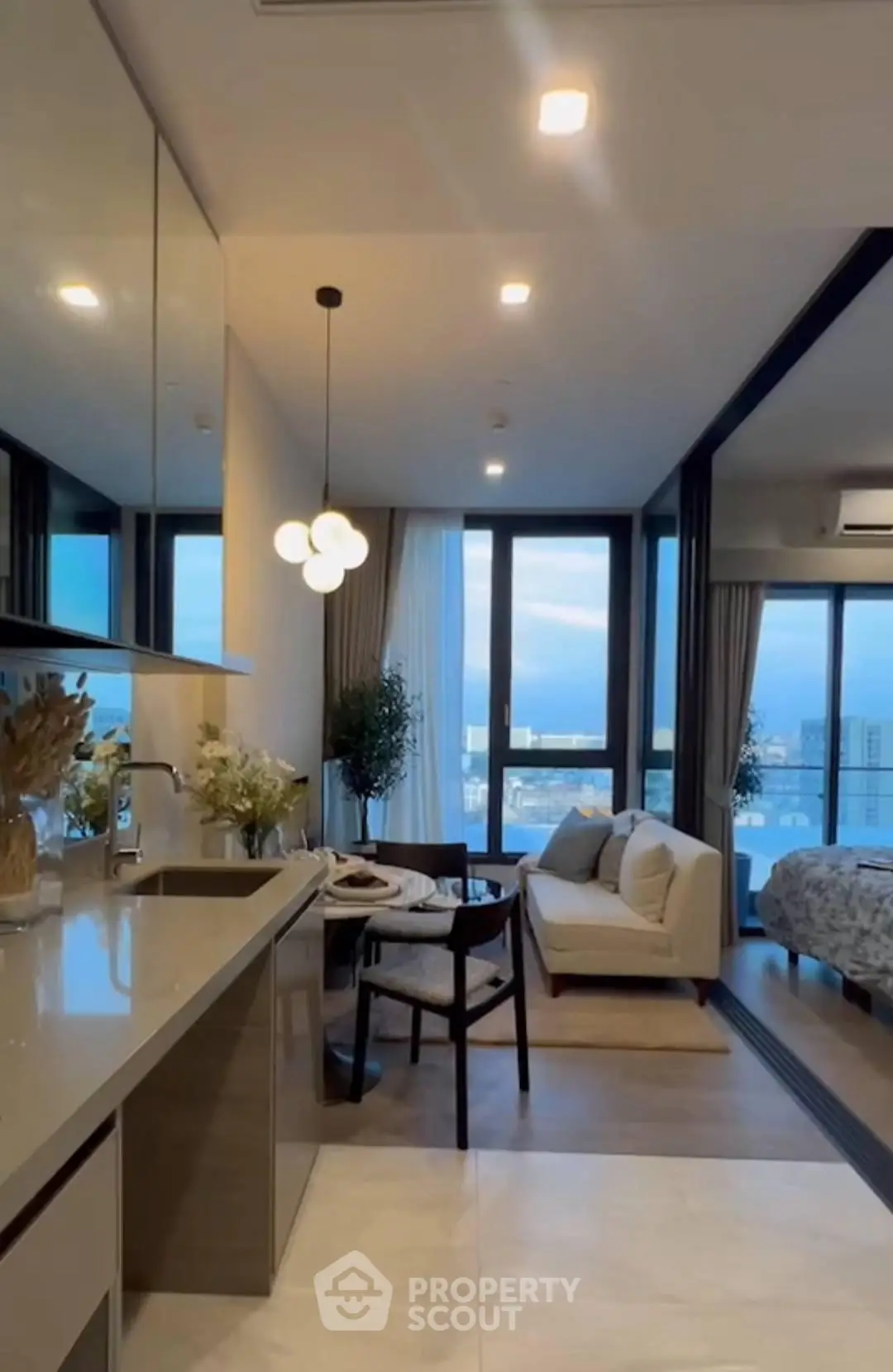 Modern open-layout living room with kitchen and stunning city view