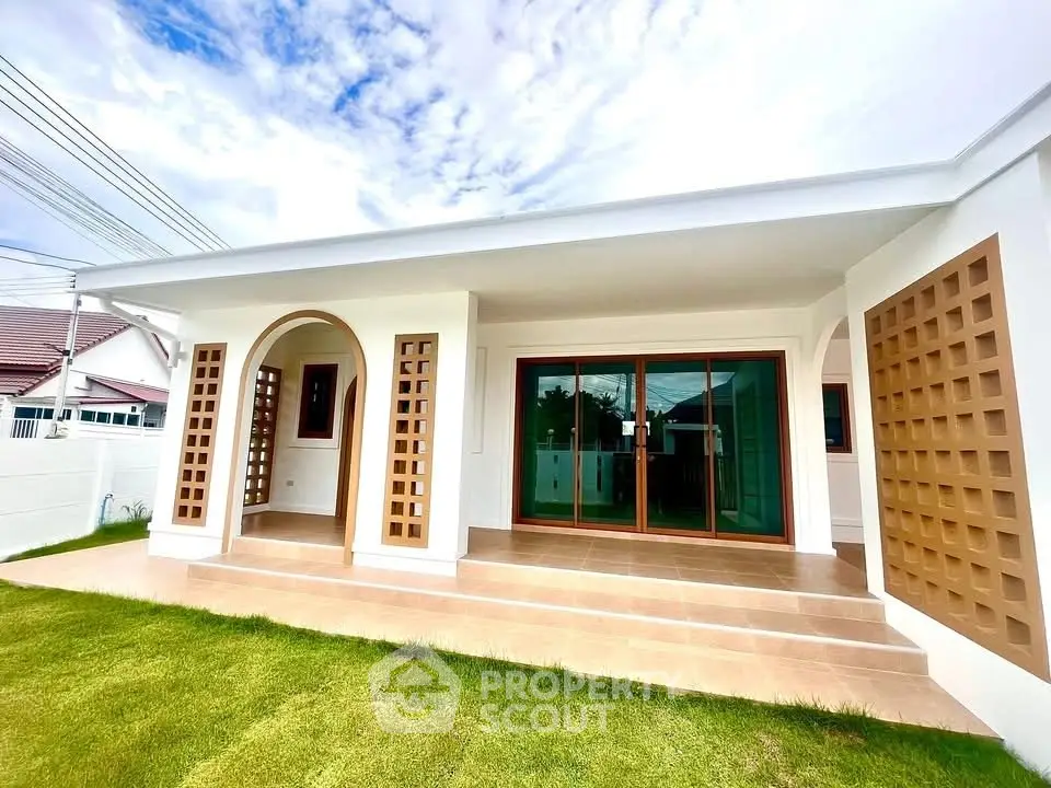 Modern single-story house with spacious porch and large glass doors