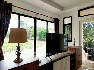 Bright living room with large windows and garden view