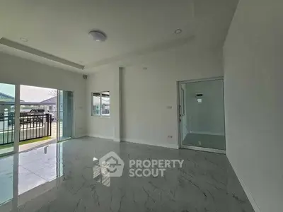 Spacious modern living room with glossy marble floors and large windows for natural light.