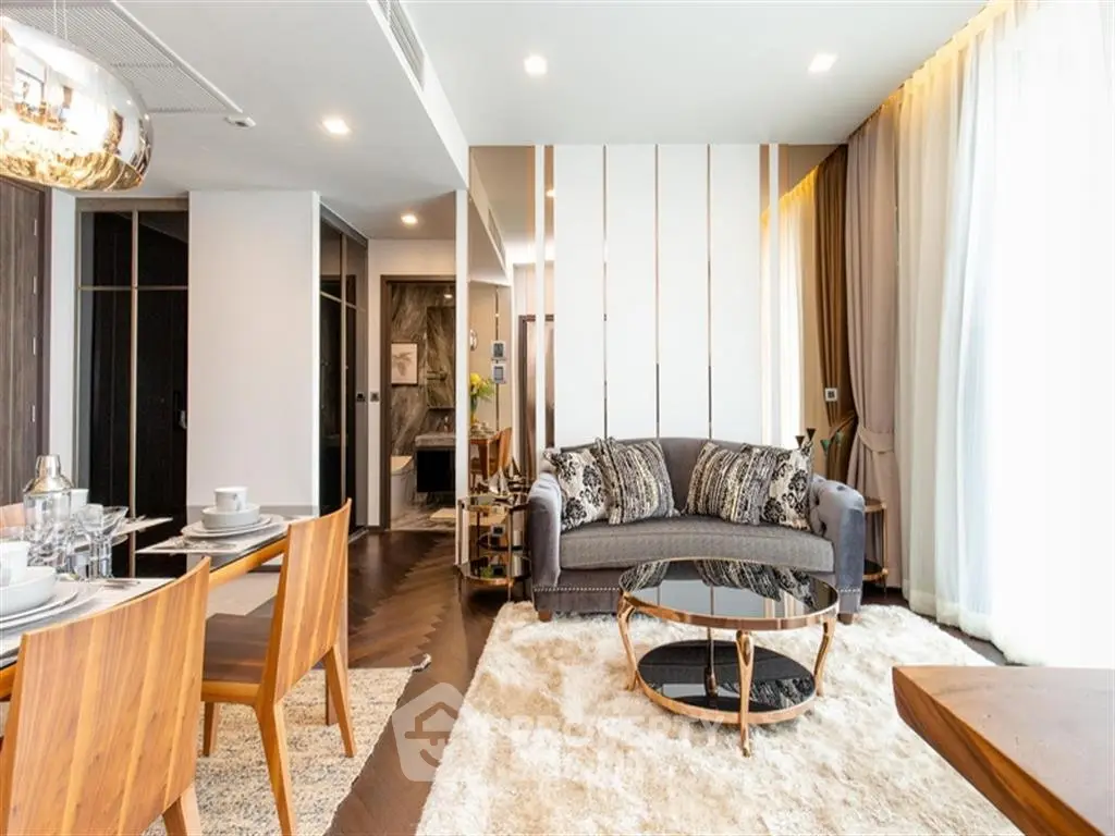 Luxurious modern living room with elegant decor and dining area, featuring stylish furniture and ambient lighting.