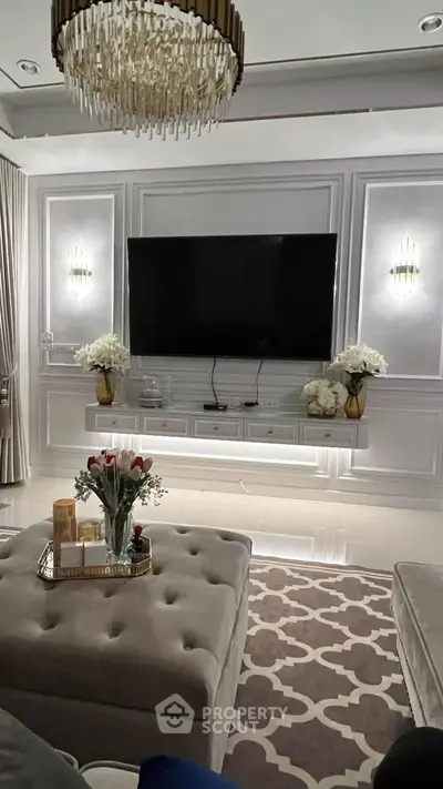 Luxurious living room with elegant decor, large TV, and plush seating for ultimate comfort.