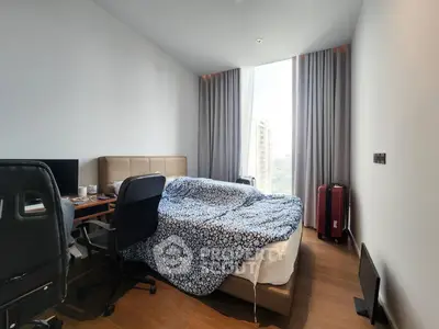 Modern bedroom with city view, featuring a cozy bed, work desk, and stylish decor.