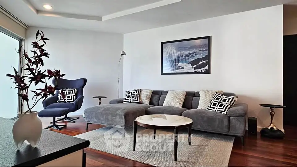 Modern living room with stylish furniture and elegant decor, featuring a cozy sofa and chic armchair.
