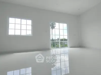 Spacious empty room with large windows and glossy floors, offering serene garden views.