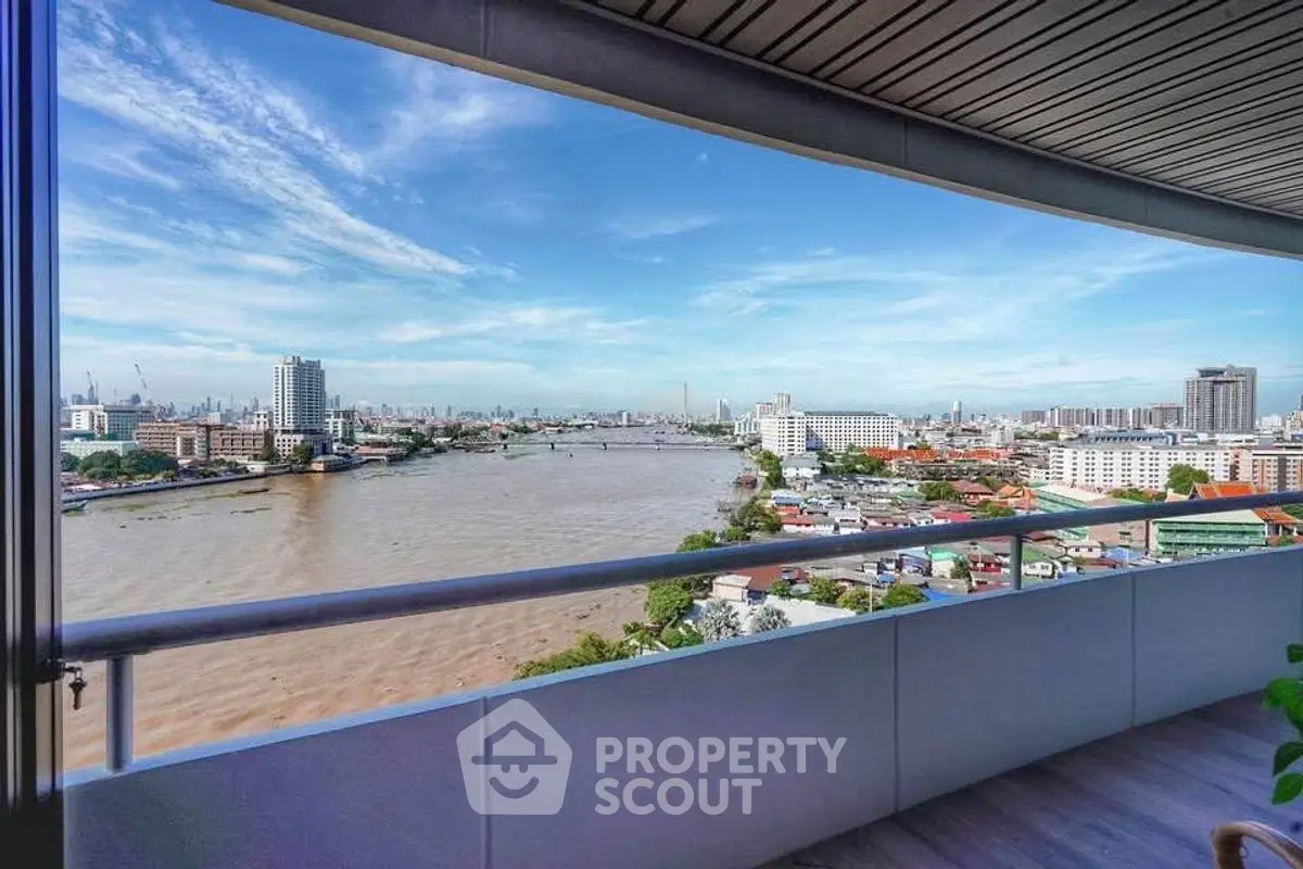 Stunning river view from a high-rise balcony in the city, perfect for relaxation.