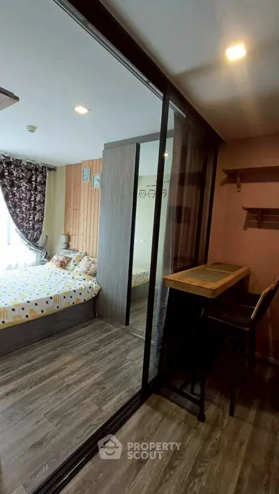 Cozy bedroom with glass partition and stylish decor in modern apartment