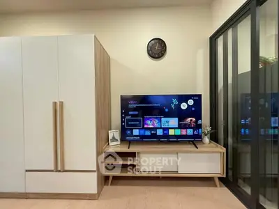 Modern living room with sleek TV setup and stylish storage solutions.