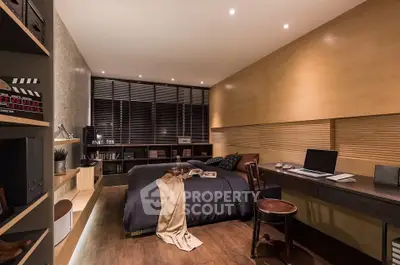 Modern bedroom with sleek design, featuring a cozy bed, stylish desk, and ambient lighting for a luxurious feel.