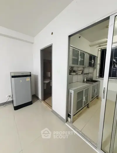 Modern kitchen with closed layout and sleek cabinetry in a contemporary apartment.