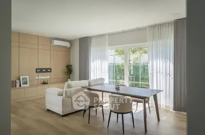 Modern living room with elegant dining area and large windows