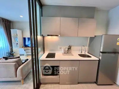 Modern open-layout kitchen with sleek appliances and cozy living area