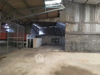 Spacious industrial warehouse with high ceilings and ample storage space.