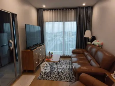 Cozy living room with leather sofa and city view balcony