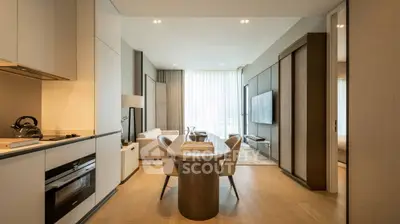Modern open-plan living room and kitchen with elegant decor and natural light