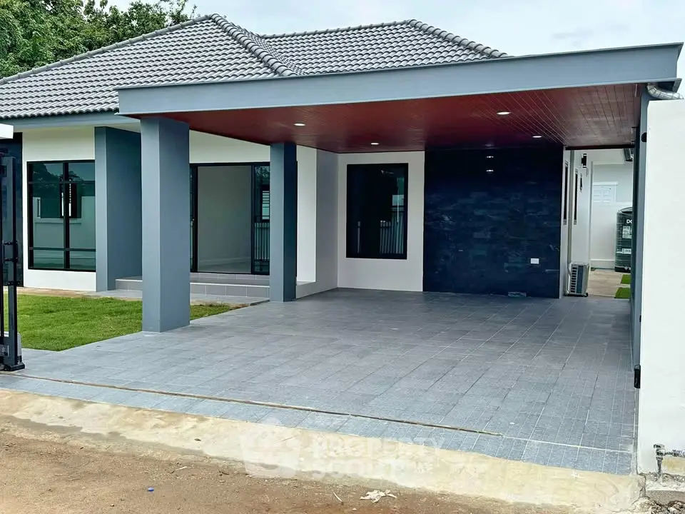 Modern single-story home with spacious carport and sleek exterior design.