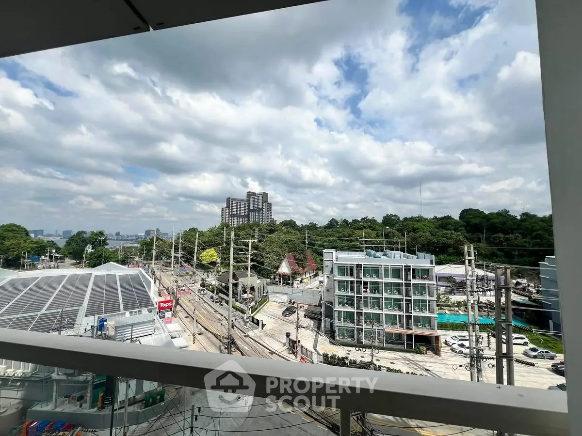 Stunning urban view from a balcony overlooking cityscape and greenery, perfect for modern living.