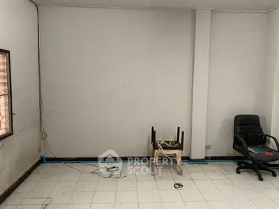 Spacious room with tiled floor and minimal furnishings, ideal for customization.