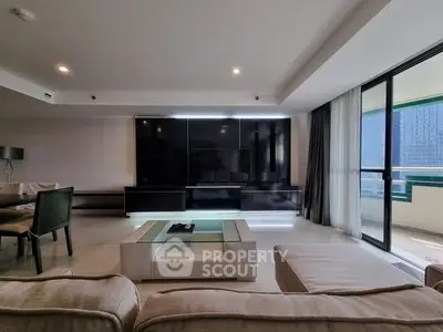 Spacious modern living room with sleek furniture and large balcony access.