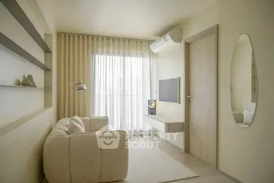 Modern minimalist living room with cozy sofa, wall-mounted TV, and elegant decor.