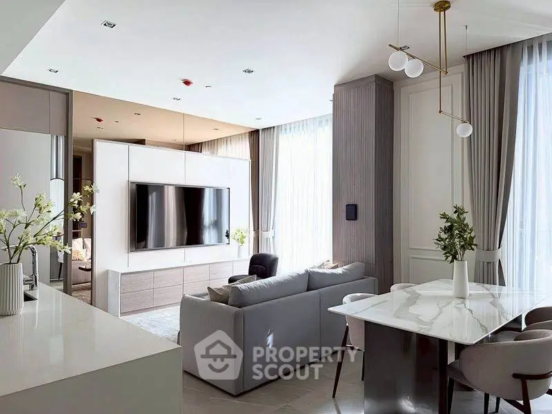 Modern living room with sleek design, large TV, and elegant dining area, perfect for contemporary living.