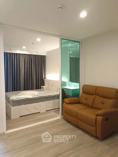 Modern bedroom with stylish decor and cozy seating area, perfect for relaxation and comfort.
