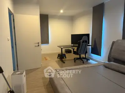 Modern bedroom with gaming setup and sleek design