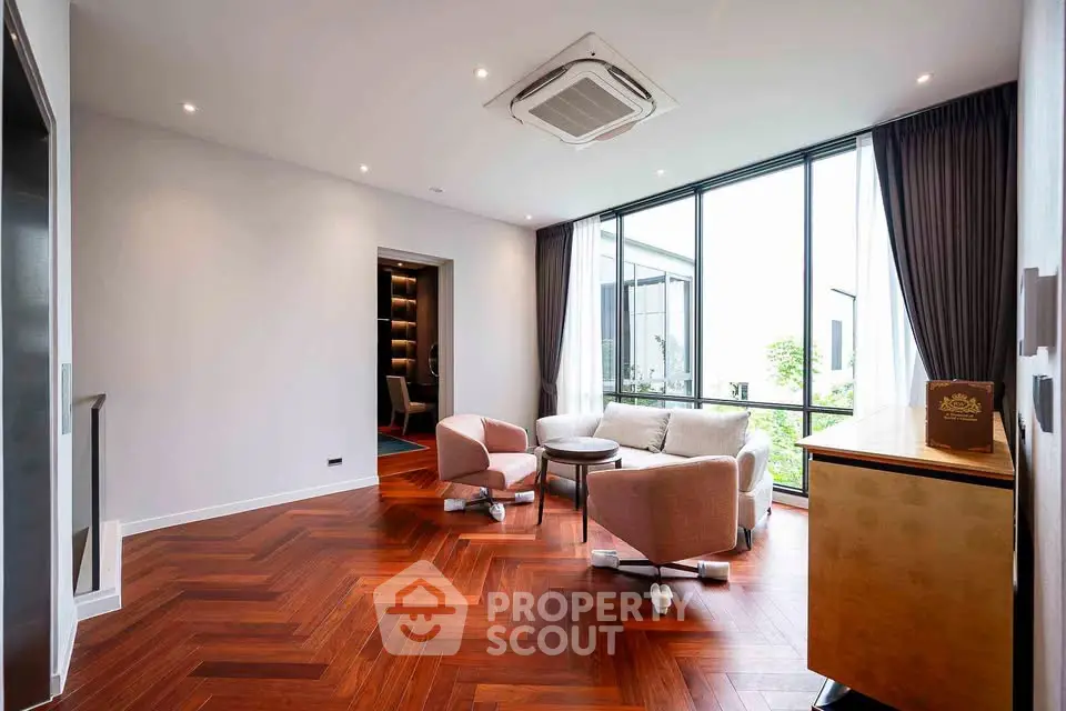 Elegant living room with modern furniture and large windows offering natural light