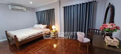 Spacious bedroom with elegant wooden flooring and stylish decor