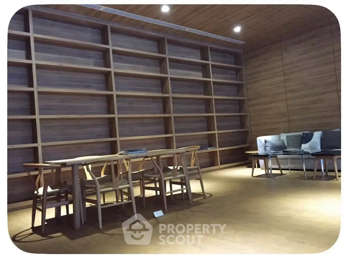 Spacious modern library with wooden shelves and cozy seating area.