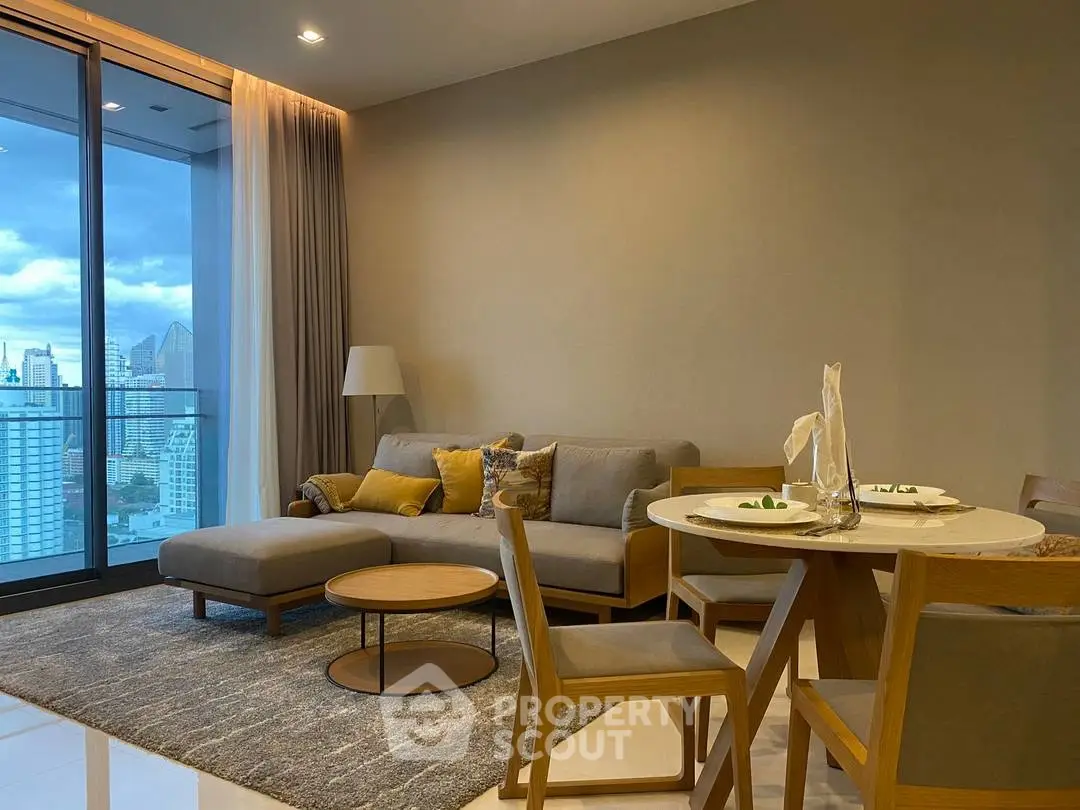 Modern living room with city view, stylish furniture, and elegant decor in a high-rise apartment.