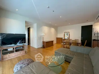 Spacious living room with modern furniture and dining area, perfect for family gatherings.