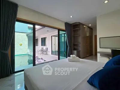 Luxurious bedroom with pool view and modern decor, perfect for relaxation and comfort.