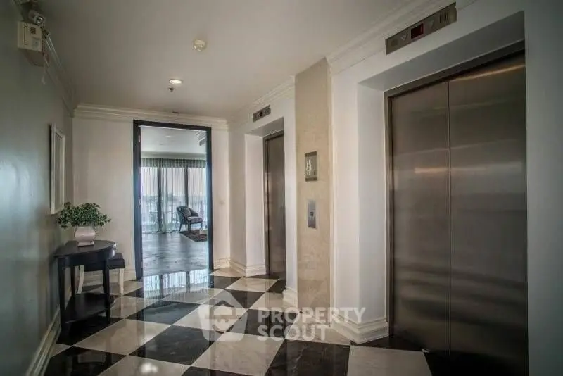 Elegant building lobby with modern elevators and stylish decor.