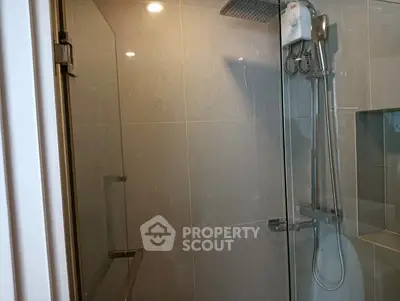 Modern bathroom with glass shower enclosure and sleek fixtures