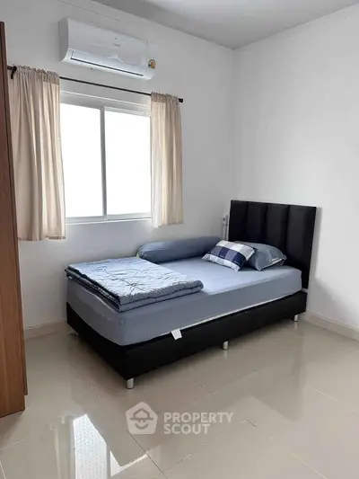 Cozy bedroom with modern bed and air conditioning, perfect for restful nights.