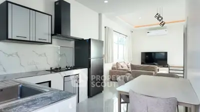 Modern open-plan kitchen and living room with sleek design and natural light.