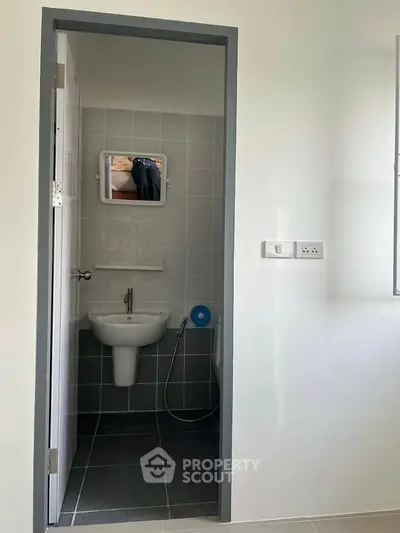 Compact bathroom with modern fixtures and minimalist design