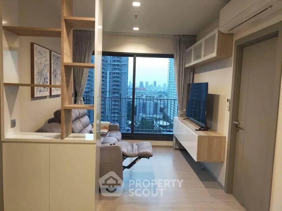 Modern living room with city view, featuring sleek furniture and large windows for natural light.