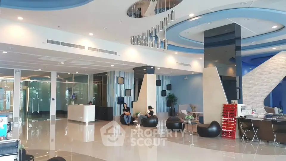 Luxurious modern lobby with sleek design and stylish seating in a high-end building.