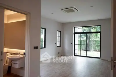 Spacious modern living room with large windows and garden view