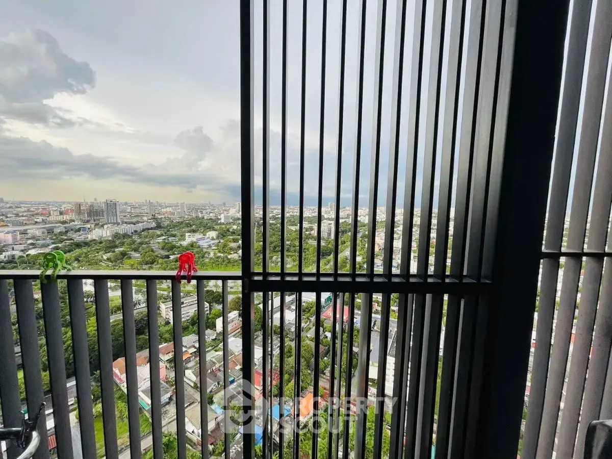 Stunning high-rise view of cityscape through modern balcony railing.