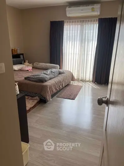 Spacious bedroom with natural light and modern decor